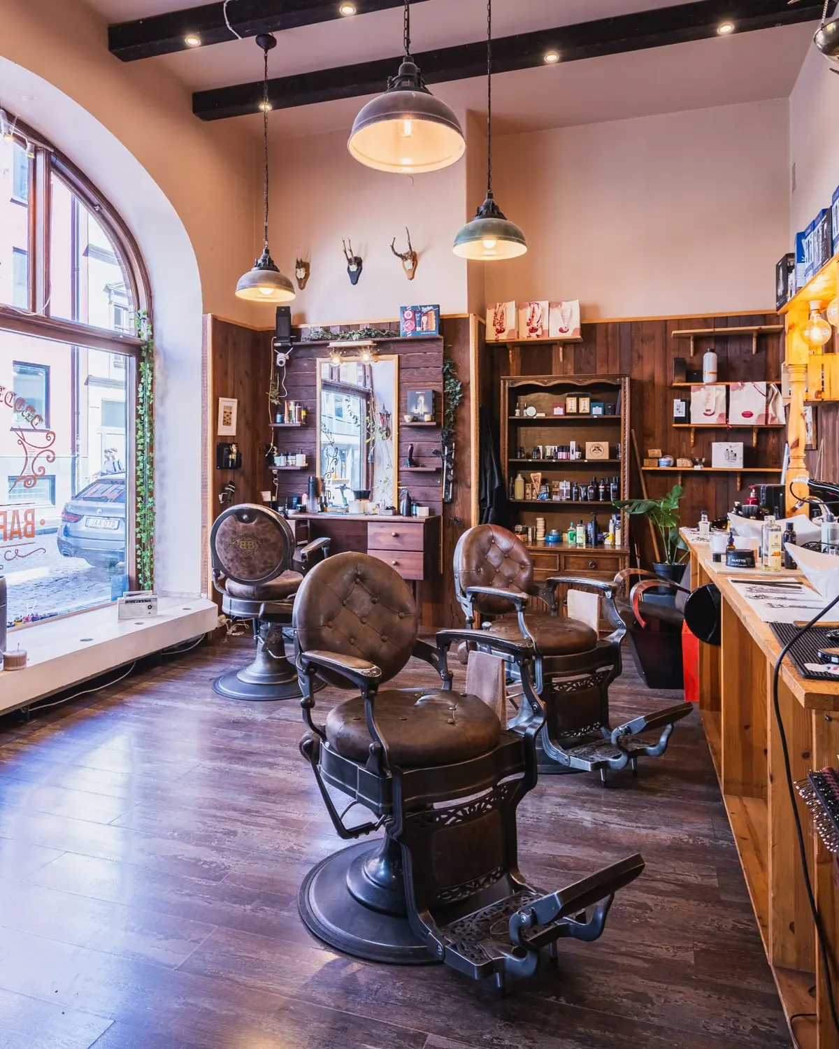 Interior of a Malmö barbershop with vintage barber chairs and wood shelving