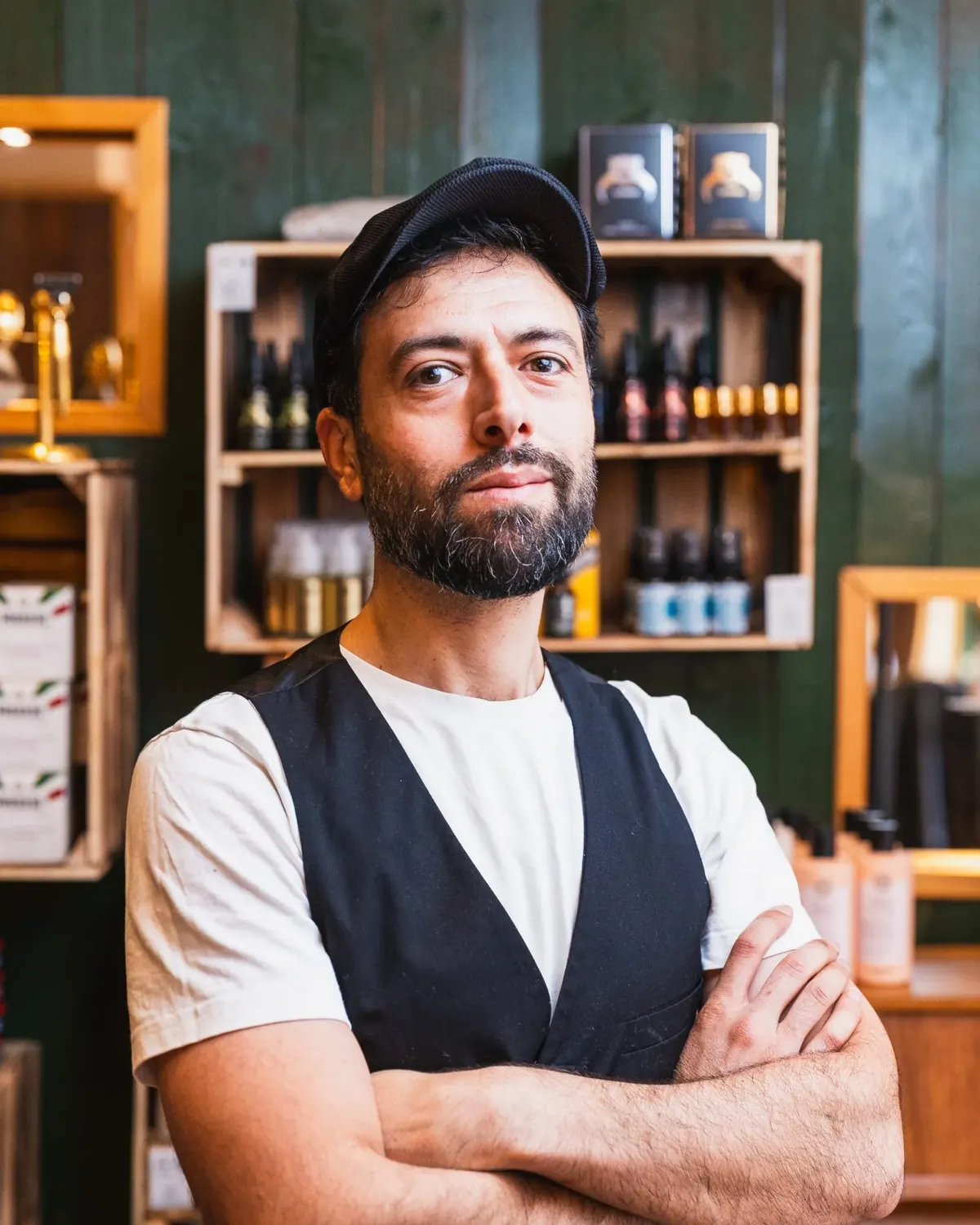 Wael standing in front of grooming product shelves at a Malmö barbershop