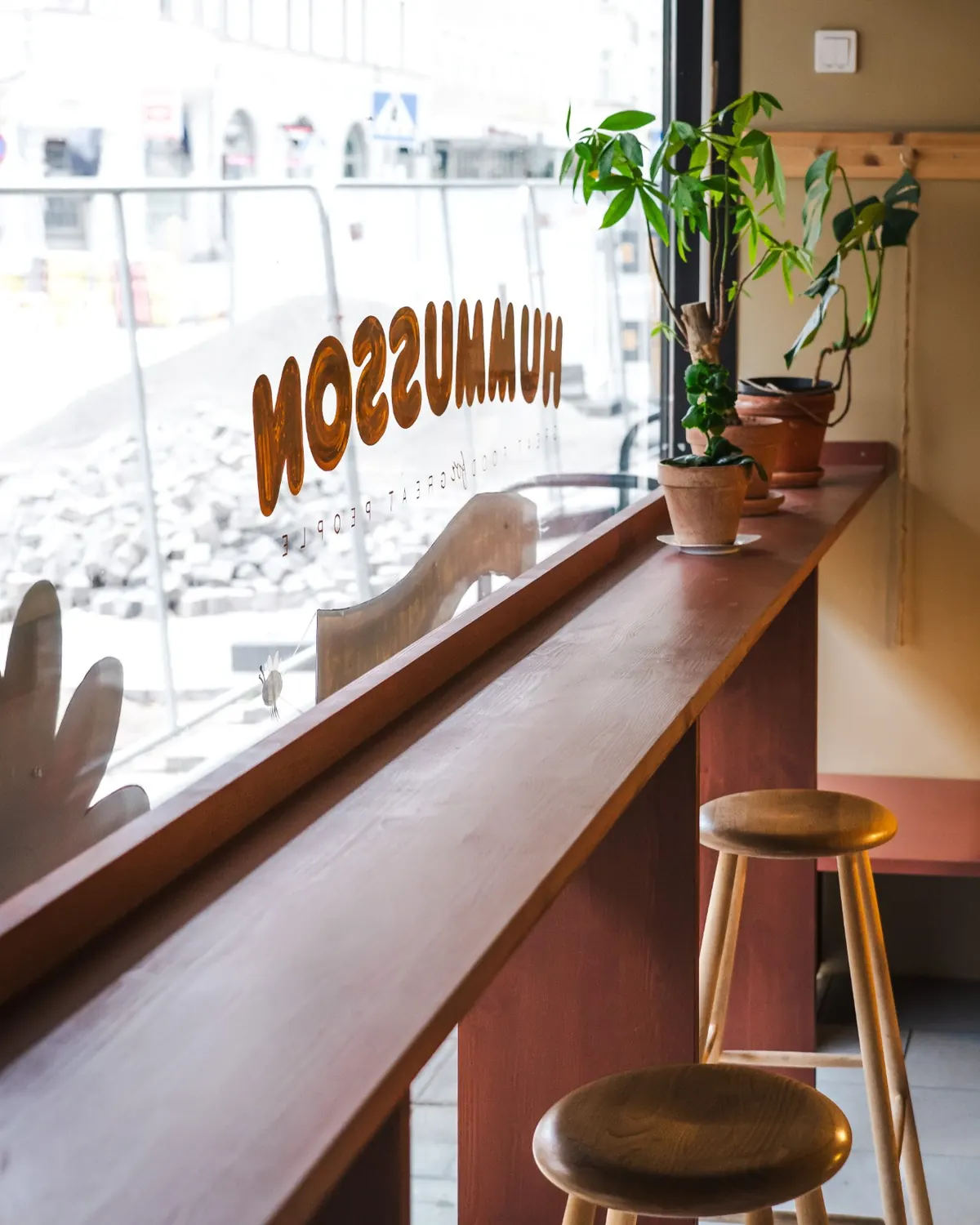 The Hummusson storefront window and bar seating, seen from inside