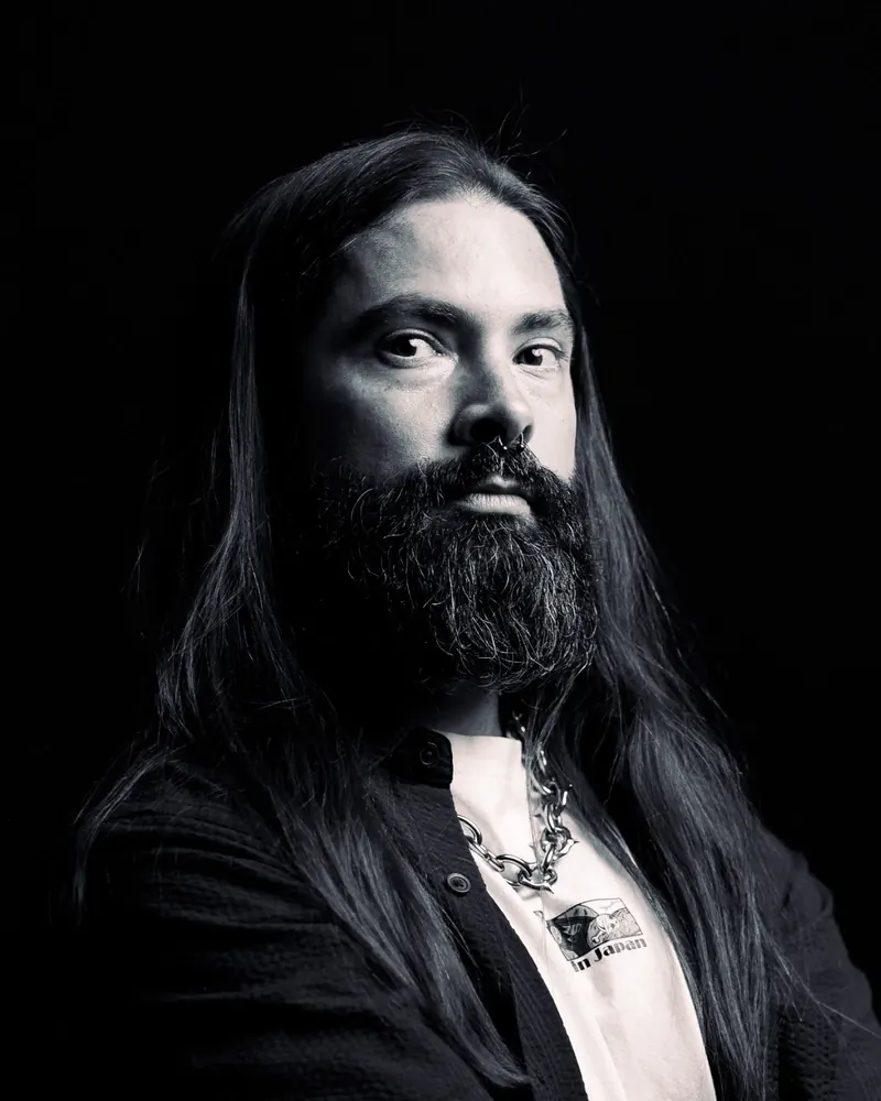 Black and white studio headshot of Charlie