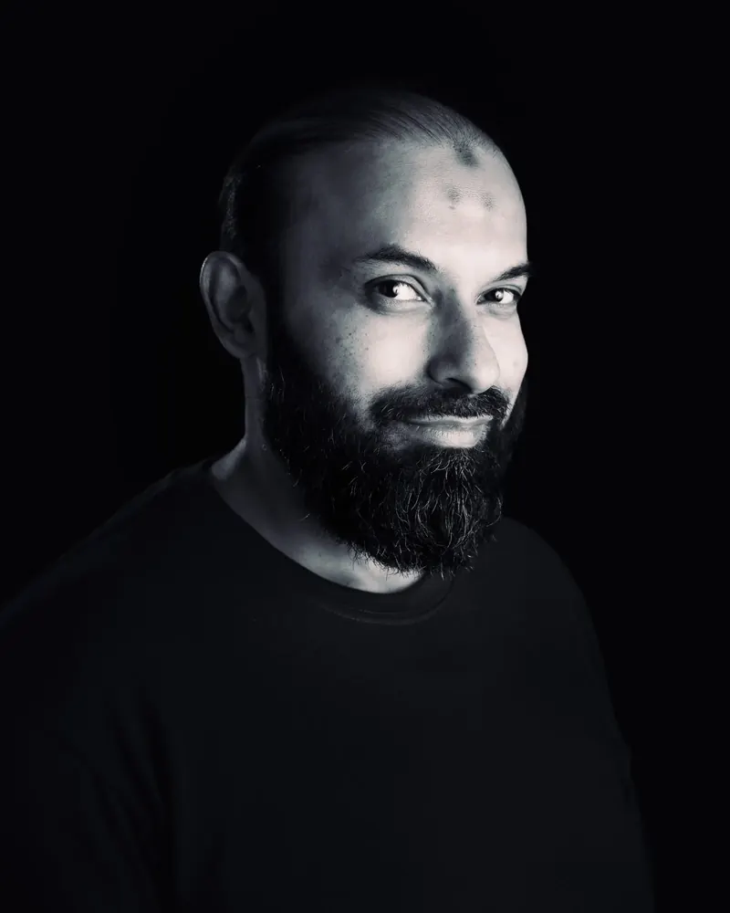 Black and white studio headshot of Mohsin